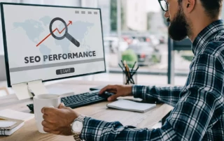 Search Engine Optimization Made Easy | Picture of man sitting in front of computer screen looking at a SEO performance chart - Juan Rojo Design Toronto