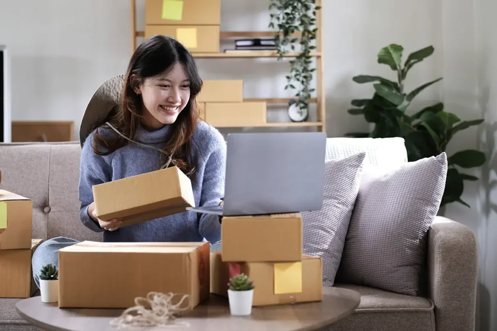 How to Build an Online Store Using WordPress | Picture of young woman fulfilling online orders in her living room, sitting on a couch - Juan Rojo Design Toronto