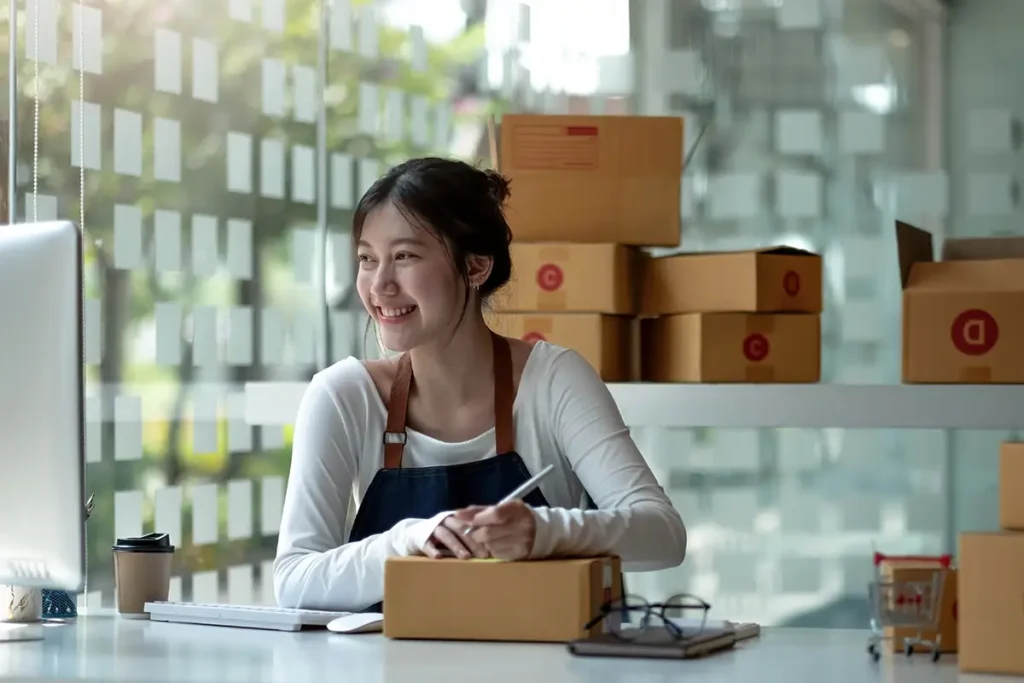 How to Use ChatGPT for Small Businesses | Picture of young Asian woman fulfilling orders for her online business - Juan Rojo Design Toronto