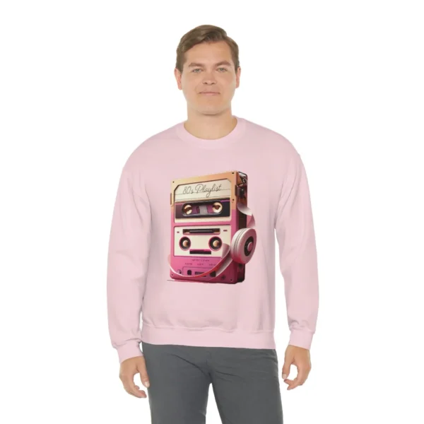 80s Playlist Sweatshirt Unisex, 80s retro hoodie, 80s style hoodie, 80s retro hoodie and Gen X | Picture of white man wearing a pink sweatshirt with the graphic of a tape player with headphones sitting on top of it and on the tape label the words 80s Playlist have been written - Juan Rojo Design Toronto