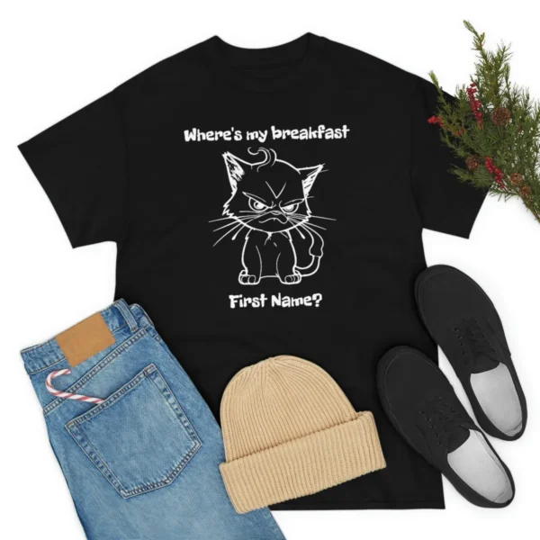 Design of angry kitten on a black t-shirt surrounded by a pair of jeans, sandals and a hat - Juan Rojo Design Toronto