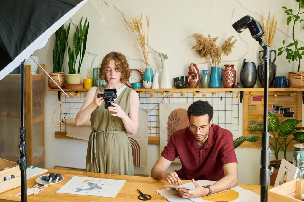 WooCommerce vs Etsy | Picture of two young entrepreneurs staging their products for a photo session - Juan Rojo Design Toronto